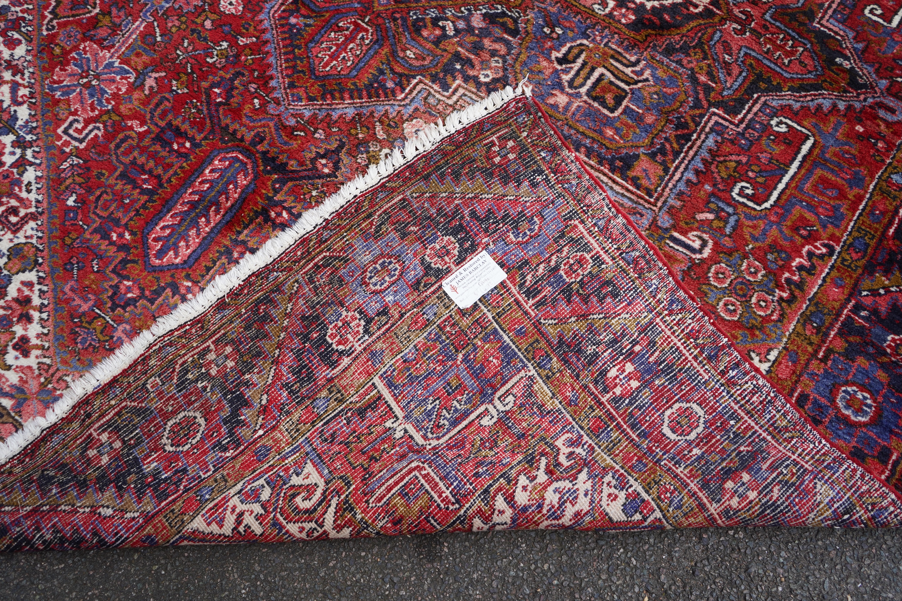 A Heriz brick red ground carpet